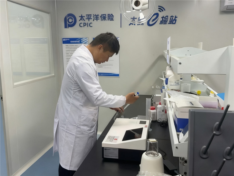 “太保e检站”内，检测员对农户送来的样品进行药物残留检测